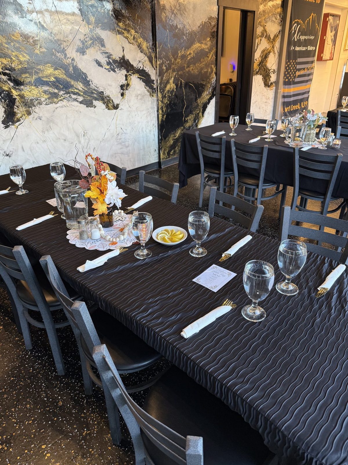 Long dining table beside the marble wall