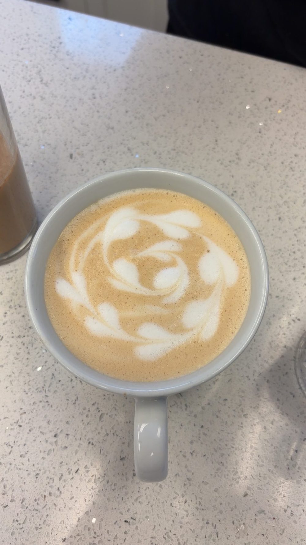 Latte with latte art in a gray mug