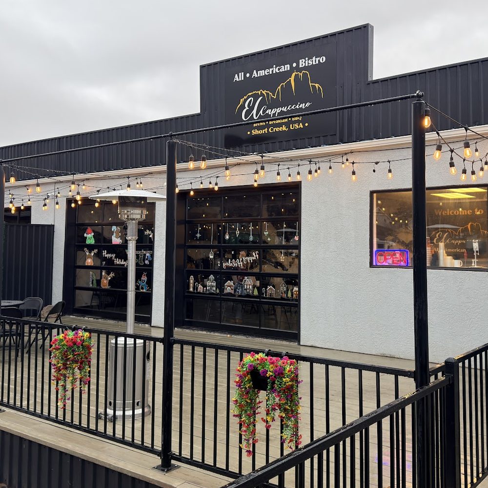 Front of El Cappuccino on Utah Avenue with its railed patio, heater and string lights