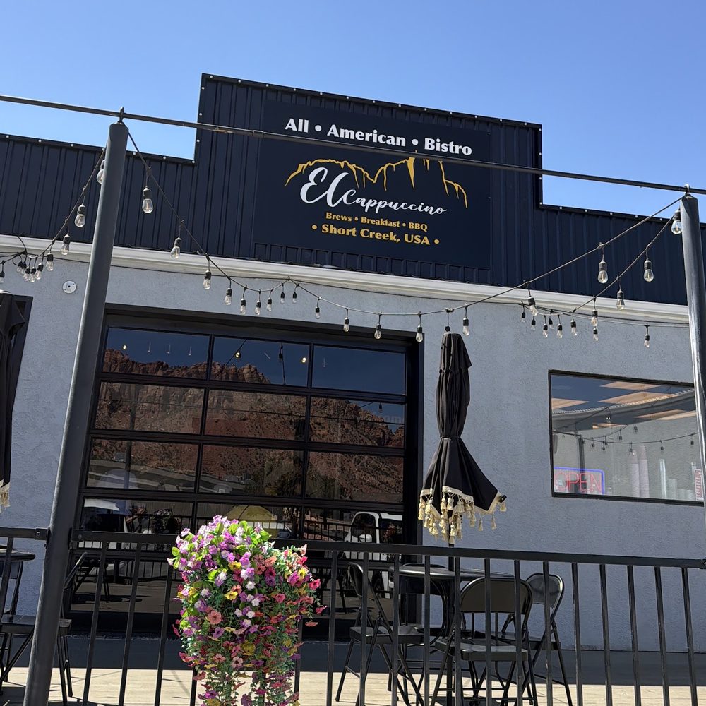 El Cappuccino patio under the black All-American Bistro sign on a sunny day